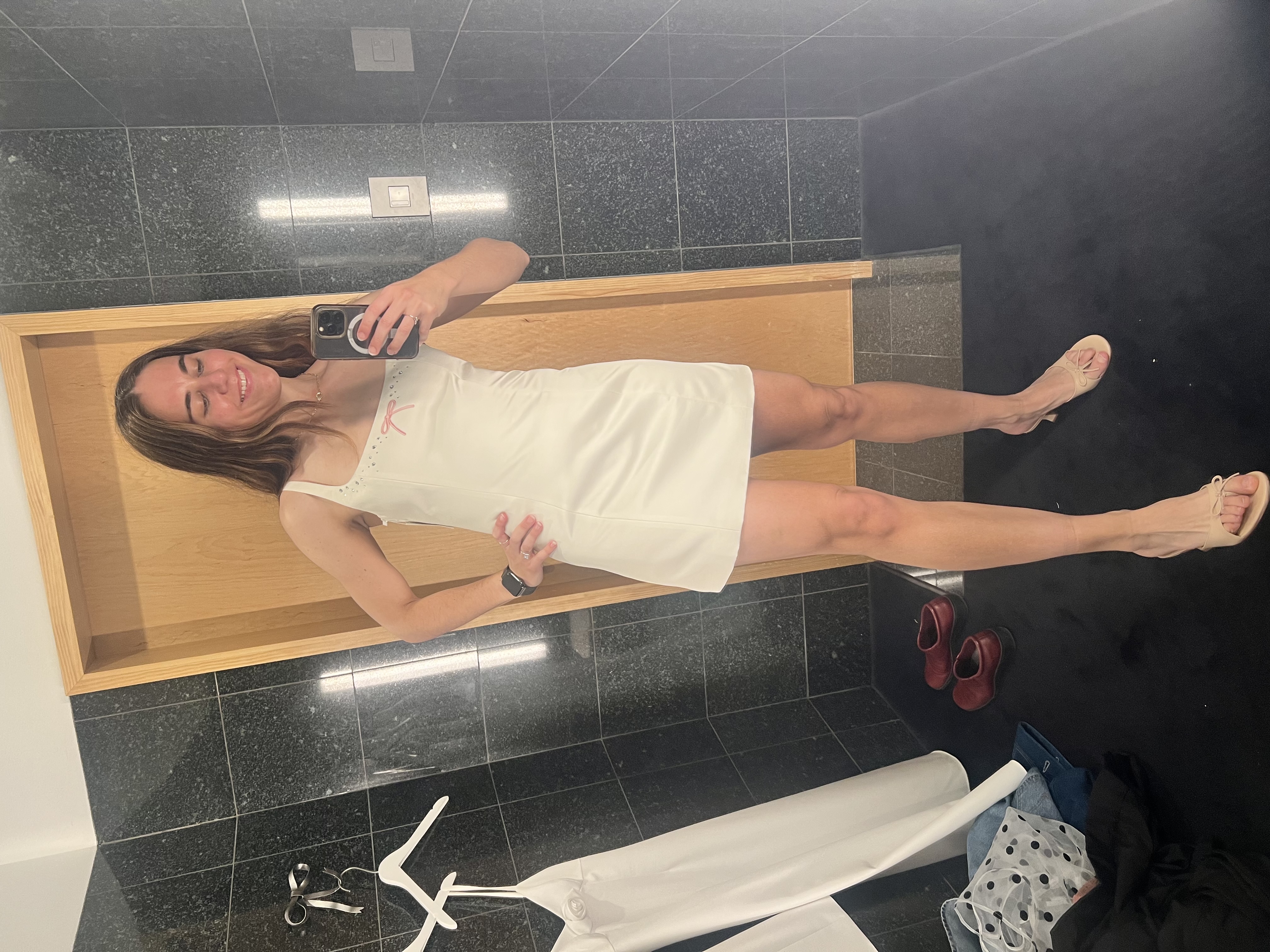 Carley trying on wedding outfits at Sandy Liang